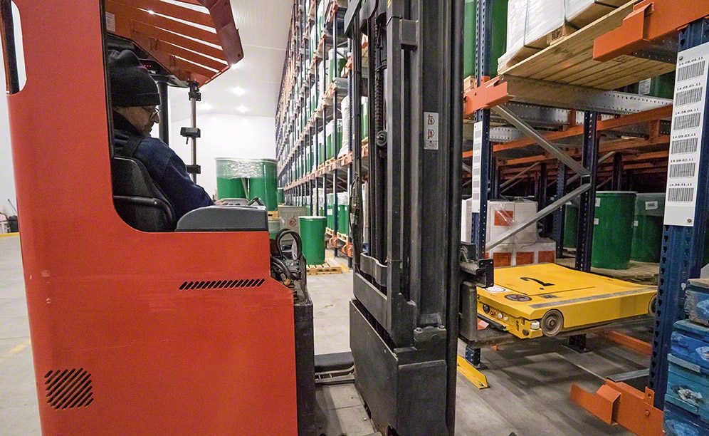 Reach trucks to deposit pallets into their assigned locations
