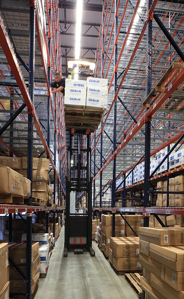 Operators work using reach trucks for handling the goods in this type of racking